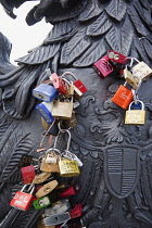 Germany, Berlin, Mitte, Young couples attached initialled padlocks to the Freidrichstrasse bridge ove rthe river Spree.