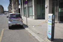 Germany, Berlin, Mitte, Citroen electric car being charged at roadside point.