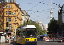 Germany, Berlin, Mitte, tram exiting Oranienburger Strasse with the Neue Synagogue and TV tower behind.