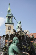 Germany, Berlin, Mitte, Neptunbrunnen fountain next to St Marienkirche in Alexanderplatz.