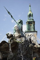 Germany, Berlin, Mitte, Neptunbrunnen fountain next to St Marienkirche in Alexanderplatz.