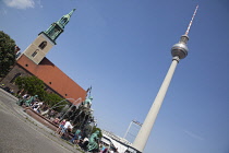 Germany, Berlin, Mitte, Fernsehturm TV Tower seen from St Marienkirche and Neptunbrunnen in Alexanderplatz.
