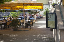 Germany, Berlin, Mitte, Cafes, restaurants and bars under leafy shade on the banks of the river Spree.