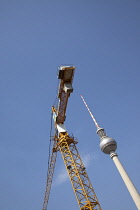 Germany, Berlin, Mitte, Fernsehturm TV Tower next to construction crane.