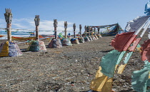 China, Tibet, Buddhist sacred religious place at the Tibetan mountain pass with a lot of waving colorful prayer flags.