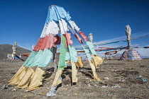 China, Tibet, Qinghai, Buddhist sacred religious place at the Tibetan mountain pass with a lot of waving colorful prayer flags.