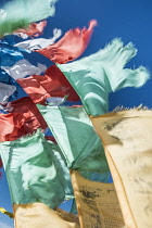 China, Tibet, Blessing colorful Tibetan prayer flags waves under the blue sky.