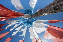 China, Tibet, Blessing colorful Tibetan prayer flags waves under the blue sky.