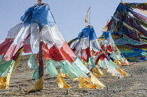 China, Tibet, Qinghai, Buddhist sacred religious place at the Tibetan mountain pass with a lot of waving colorful prayer flags.