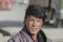 China, Tibet, Attractive face of a young native Tibetan men at Kham region