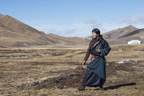 China, Tibet,Young woman from a nomad family on a highland pasture.