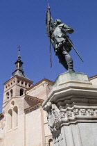 Spain, Castille-Leon, Segovia, Statue of Juan Bravo by A.Marinas with Church of St Martin in the background.