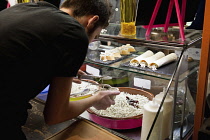 Spain, Madrid, Mercado de San Miguel, serving up elvers.