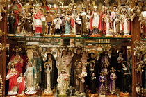 Spain, Madrid, Religious statues and icons on display in shop window.