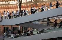 Spain, Madrid, Passengers using the escalators inside the terminus of the Atocha Railway Station.