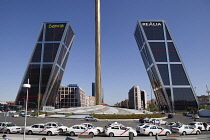 Spain, Madrid, Puerta de Europa with the monument to Calvo Sotelo in the foreground at Plaza de Castilla.