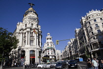 Spain, Madrid, Busy traffic on Alcala Grand Via junction next to the Metropolis building.