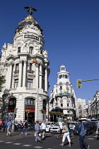 Spain, Madrid, Busy traffic on Alcala Grand Via junction next to the Metropolis building.