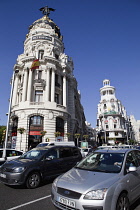 Spain, Madrid, Busy traffic on Alcala Grand Via junction next to the Metropolis building.