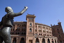 Spain, Madrid, Statue of a matador with the Plaza de Toros de las Ventas in the background.