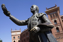 Spain, Madrid, Statue of a matador with the Plaza de Toros de las Ventas in the background.