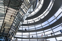 Germany, Berlin, Mitte, Tiergarten, interior of the glass dome on the top of the Reichstag building designed by architect Norman Foster with a double-helix spiral ramp around the mirrored cone that re...