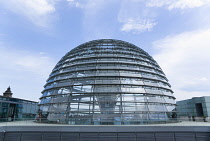 Germany, Berlin, Mitte, Tiergarten, exterior of the glass dome on the top of the Reichstag building designed by architect Norman Foster with a double-helix spiral ramp around the mirrored cone that re...