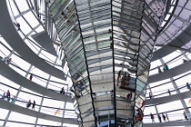 Germany, Berlin, Mitte, Tiergarten, interior of the glass dome on the top of the Reichstag building designed by architect Norman Foster with a double-helix spiral ramp around the mirrored cone that re...