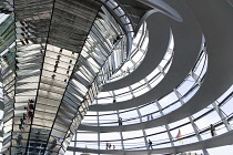 Germany, Berlin, Mitte, Tiergarten, interior of the glass dome on the top of the Reichstag building designed by architect Norman Foster with a double-helix spiral ramp around the mirrored cone that re...