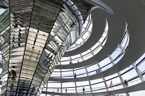Germany, Berlin, Mitte, Tiergarten, interior of the glass dome on the top of the Reichstag building designed by architect Norman Foster with a double-helix spiral ramp around the mirrored cone that re...
