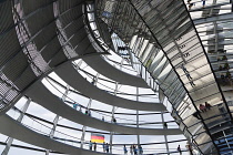Germany, Berlin, Mitte, Tiergarten, interior of the glass dome on the top of the Reichstag building designed by architect Norman Foster with a double-helix spiral ramp around the mirrored cone that re...