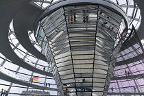 Germany, Berlin, Mitte, Tiergarten, interior of the glass dome on the top of the Reichstag building designed by architect Norman Foster with a double-helix spiral ramp around the mirrored cone that re...