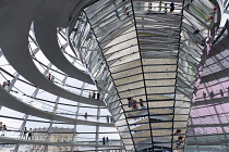 Germany, Berlin, Mitte, Tiergarten, interior of the glass dome on the top of the Reichstag building designed by architect Norman Foster with a double-helix spiral ramp around the mirrored cone that re...