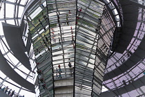 Germany, Berlin, Mitte, Tiergarten, interior of the glass dome on the top of the Reichstag building designed by architect Norman Foster with a double-helix spiral ramp around the mirrored cone that re...
