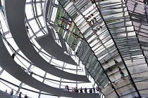 Germany, Berlin, Mitte, Tiergarten, interior of the glass dome on the top of the Reichstag building designed by architect Norman Foster with a double-helix spiral ramp around the mirrored cone that re...