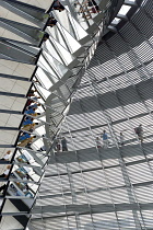 Germany, Berlin, Mitte, Tiergarten, interior of the glass dome on the top of the Reichstag building designed by architect Norman Foster with a double-helix spiral ramp around the mirrored cone that re...