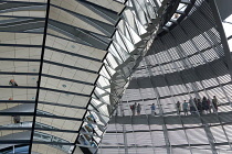 Germany, Berlin, Mitte, Tiergarten, interior of the glass dome on the top of the Reichstag building designed by architect Norman Foster with a double-helix spiral ramp around the mirrored cone that re...