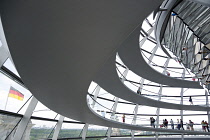 Germany, Berlin, Mitte, Tiergarten, interior of the glass dome on the top of the Reichstag building designed by architect Norman Foster with a double-helix spiral ramp around the mirrored cone that re...