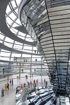 Germany, Berlin, Mitte, Tiergarten, interior of the glass dome on the top of the Reichstag building designed by architect Norman Foster with a double-helix spiral ramp around the mirrored cone that re...