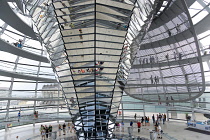 Germany, Berlin, Mitte, Tiergarten, interior of the glass dome on the top of the Reichstag building designed by architect Norman Foster with a double-helix spiral ramp around the mirrored cone that re...
