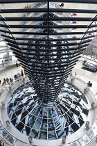 Germany, Berlin, Mitte, Tiergarten, interior of the glass dome on the top of the Reichstag building designed by architect Norman Foster with a double-helix spiral ramp around the mirrored cone that re...