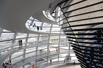Germany, Berlin, Mitte, Tiergarten, interior of the glass dome on the top of the Reichstag building designed by architect Norman Foster with a double-helix spiral ramp around the mirrored cone that re...