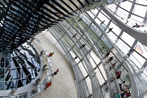 Germany, Berlin, Mitte, Tiergarten, interior of the glass dome on the top of the Reichstag building designed by architect Norman Foster with a double-helix spiral ramp around the mirrored cone that re...