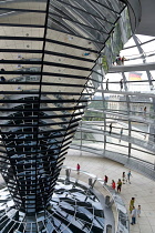 Germany, Berlin, Mitte, Tiergarten, interior of the glass dome on the top of the Reichstag building designed by architect Norman Foster with a double-helix spiral ramp around the mirrored cone that re...