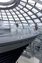 Germany, Berlin, Mitte, Tiergarten, interior of the glass dome on the top of the Reichstag building designed by architect Norman Foster with a double-helix spiral ramp around the mirrored cone that re...