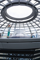 Germany, Berlin, Mitte, Tiergarten, interior of the glass dome on the top of the Reichstag building designed by architect Norman Foster with the hot air vent on top of the mirrored cone that reflect l...