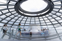 Germany, Berlin, Mitte, Tiergarten, interior of the glass dome on the top of the Reichstag building designed by architect Norman Foster with the hot air vent on top of the mirrored cone that reflect l...