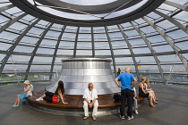 Germany, Berlin, Mitte, Tiergarten, interior of the glass dome on the top of the Reichstag building designed by architect Norman Foster with the hot air vent on top of the mirrored cone that reflect l...