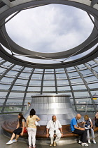 Germany, Berlin, Mitte, Tiergarten, interior of the glass dome on the top of the Reichstag building designed by architect Norman Foster with the hot air vent on top of the mirrored cone that reflect l...