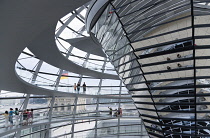 Germany, Berlin, Mitte, Tiergarten, interior of the glass dome on the top of the Reichstag building designed by architect Norman Foster with a double-helix spiral ramp around the mirrored cone that re...